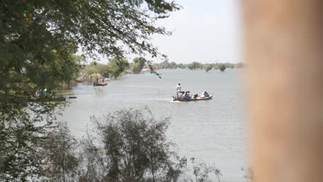 Revealing-shot-of-the-boat-carrying-multiple-to-their-destination-in-the-lake-near-Maher-Sindh