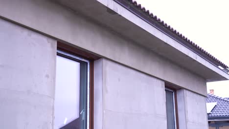 house facade with fresh cement plaster and newly installed modern window frames