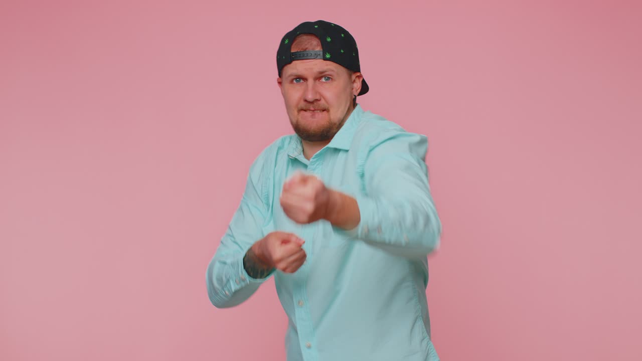 Mime young adult man pulling an imaginary unreal invisible rope showing how enduring strong he is