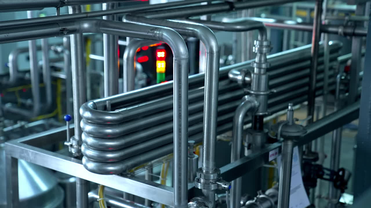 Stainless steel tubes as a part of complicated system at milk factory. Up to date technological manufacturing of dairy products.