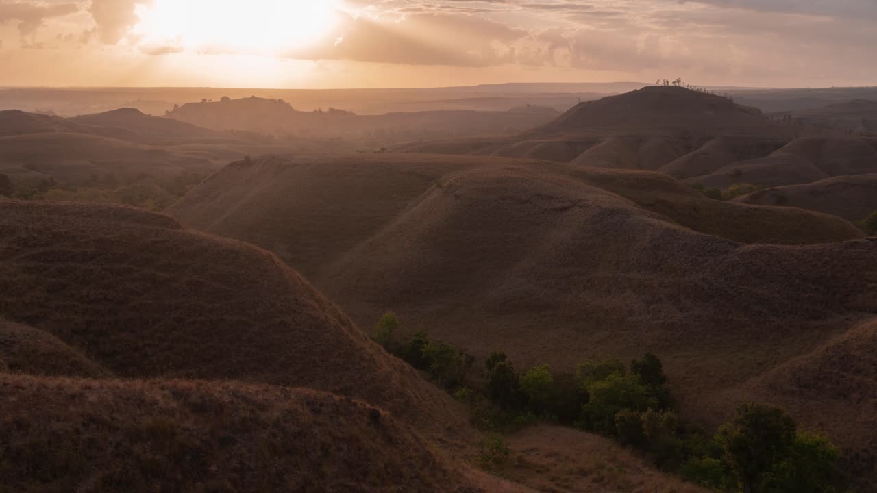 Vasto paesaggio di colline aride al tramonto