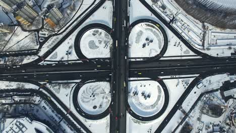 top view highway intersection in winter city. cars traffic on road junction