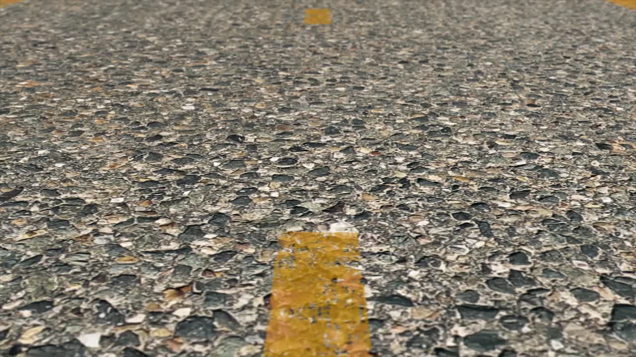Close up view of road surface with yellow line
