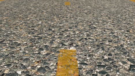 close up view of road surface with yellow line