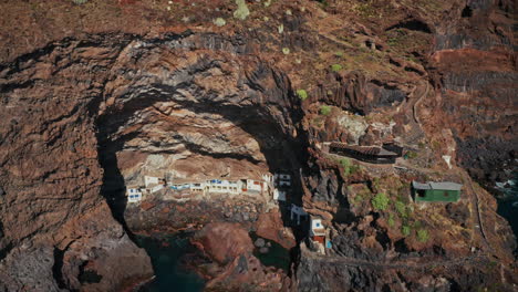 aerial drone shot over the poris de la candelaria cave in la palma island, canary islands, spain.
exclusive summer holidays private properties located inside a cave along the rugged coastline.