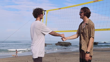 friends shaking hands on the beach.