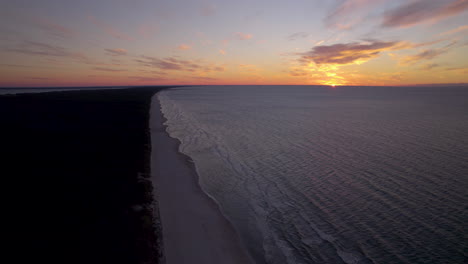 dramatic colorful sunset over baltic sea horizon level from krynica morska spit in poland aerial view