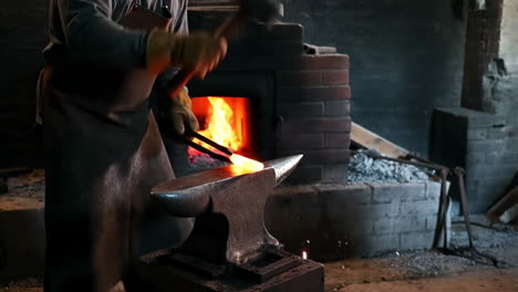 blacksmith forging hot metal on an anvil