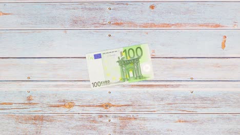 two green bricks transform into one hundred euro banknote white hand hit - stop motion