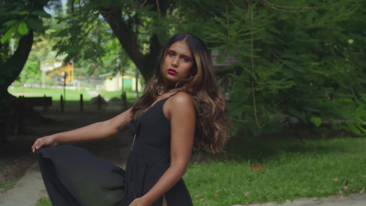 The gentle river brings a sense of serenity to a girl in a black dress.
