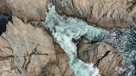 Aerial-View-of-waves-crashing-on-rock-on-Highway-1,-Shoreline-Coastal