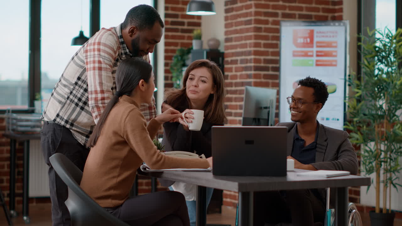 Multiethnic group of people laughing and having fun at work