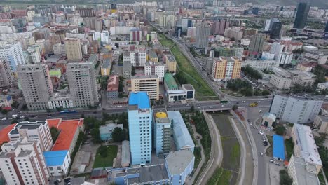 aerial drone shot over a district in ulaanbaatar mongolia. discovering mountains