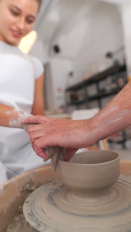 people learning pottery on a wheel