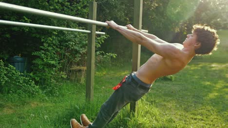 Fit-young-man-topless-doing-pull-up-exercise-on-parallel-bars-with-retracted-scapula-shoulder-blades