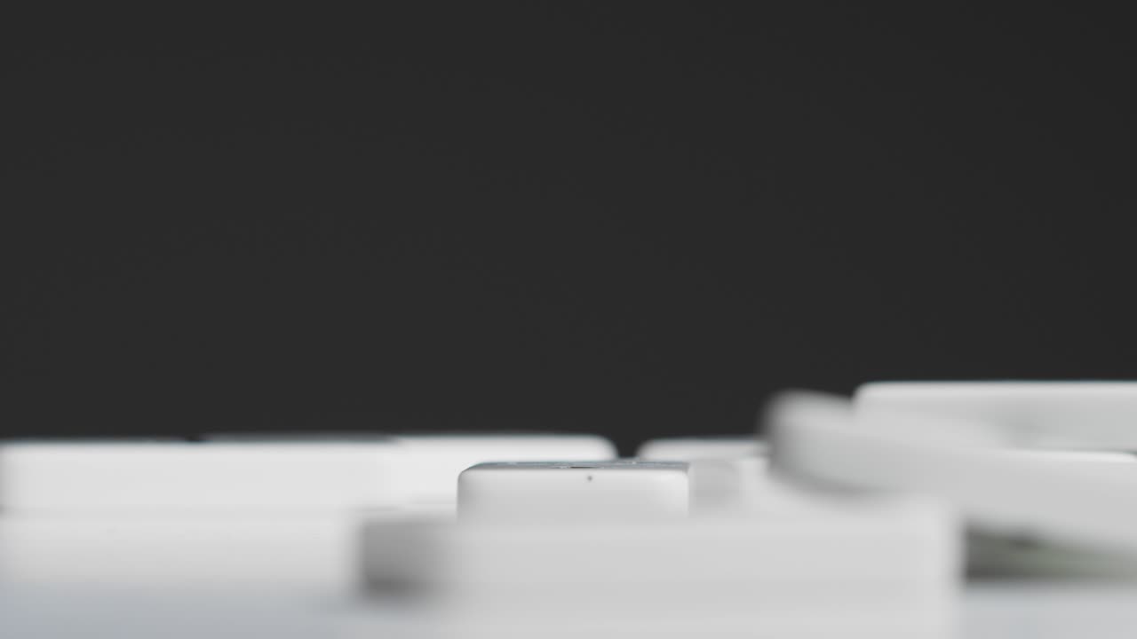 Mid Shot of Person Dropping Dominoes