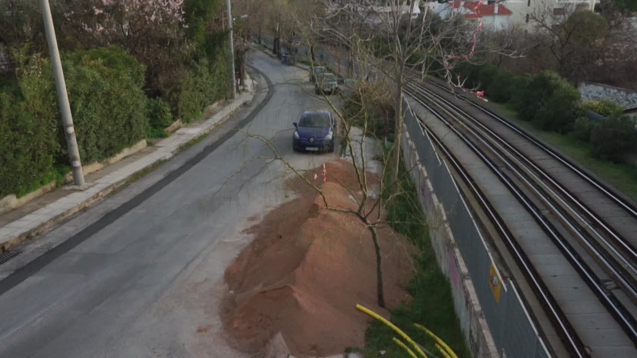 Tilt shot from a steel ladder, revealing railway of Athens public transportation system