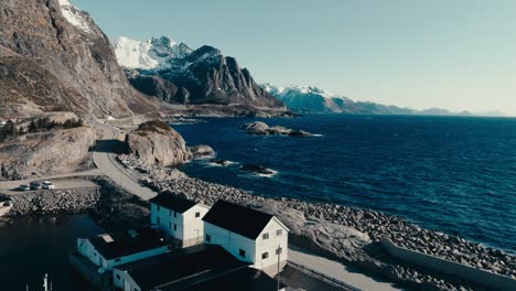 Coastal Road, Boathouse And Fishing Boat In Reine, Norway. - aerial shot