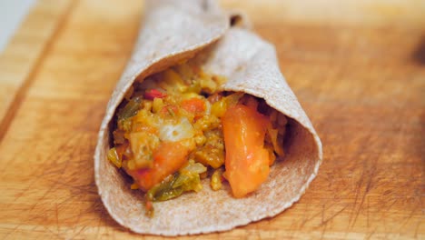 stunning close up of homemade mexican fajitas made with whole wheat tortilla on wooden board