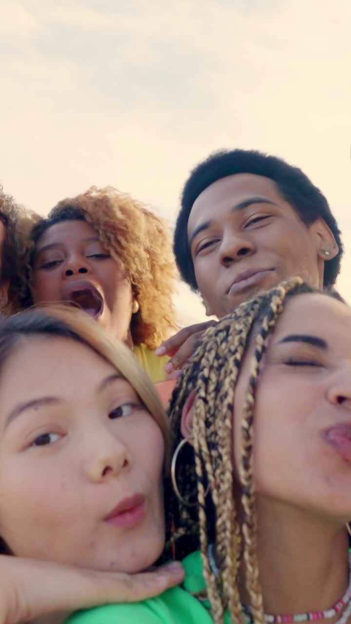 Happy latin woman taking selfie with multi-ethnic friends outdoors