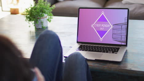 Woman-at-table-using-laptop,-online-shopping-on-cyber-monday,-slow-motion