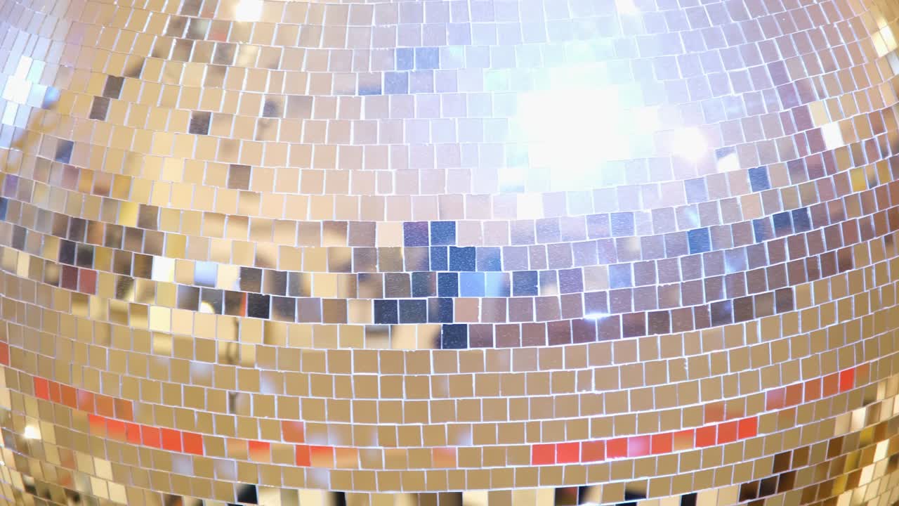 Bright large golden disco ball close up 4k resolution video Rotating retro discoball background