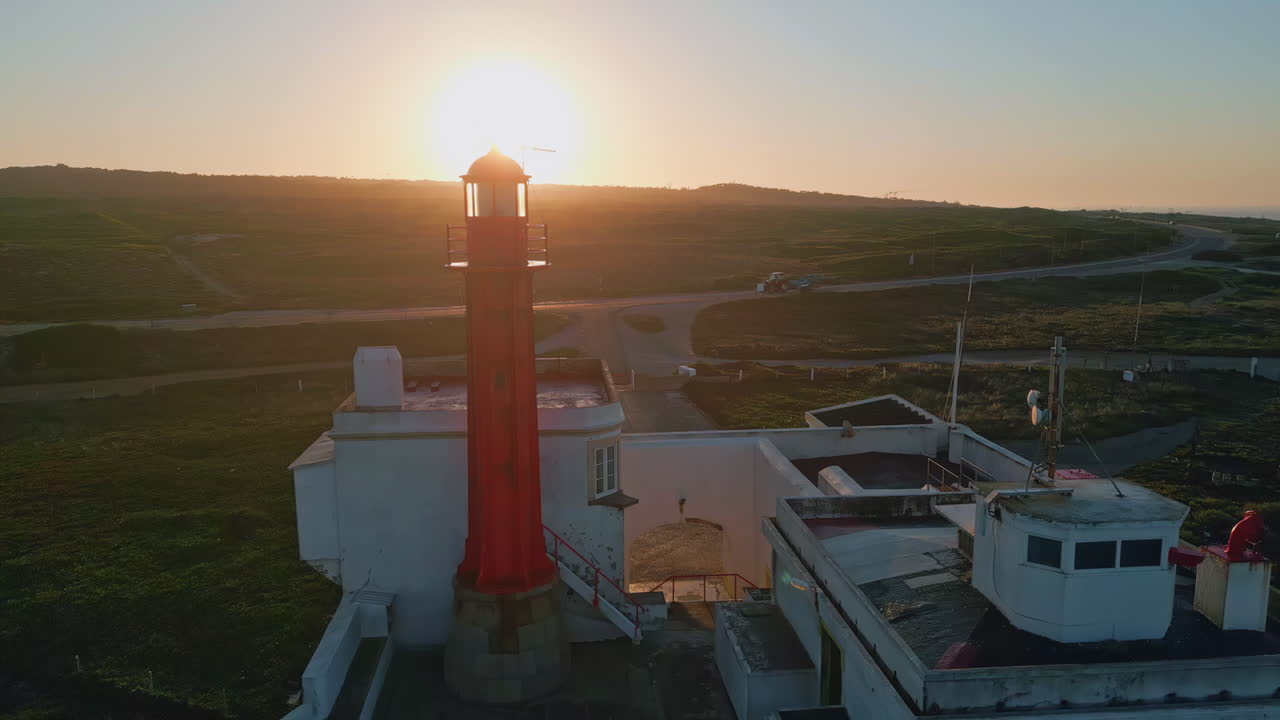 Amazing sunrise ocean lighthouse drone view. Bright morning dawn at beacon