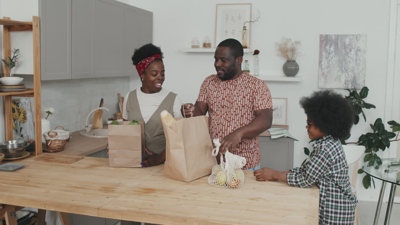 Happy African-American Family Returning Home from Food Shopping