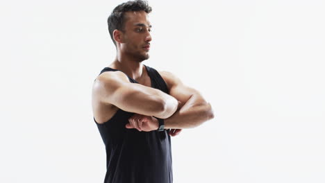 young biracial athlete man stretches before a workout on a white background, with copy space