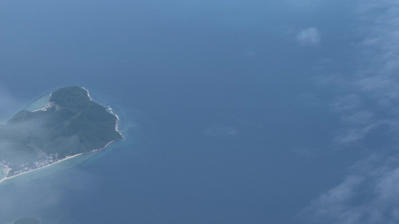 Flight over small islands in the Philippines Pacific ocean Southeast Asia travel, window view