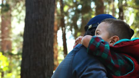 father embracing son in the park