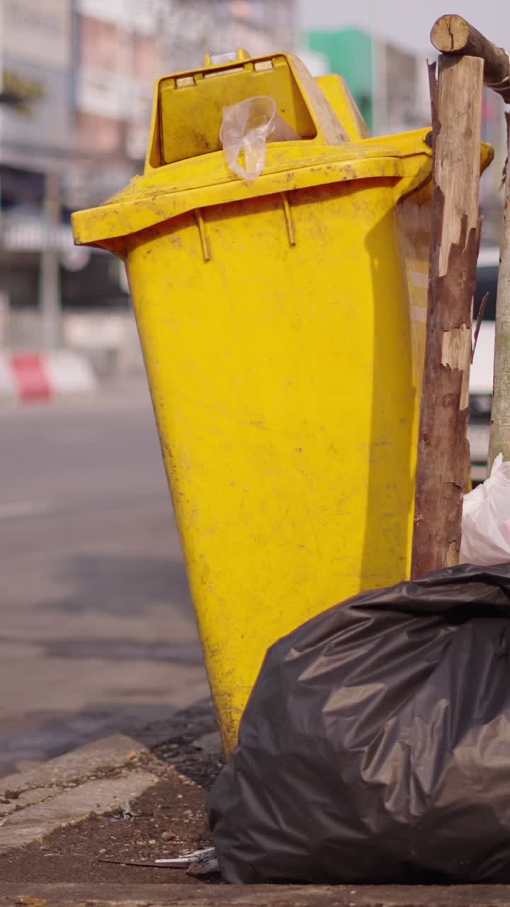 Yellow Trash Can by the Street