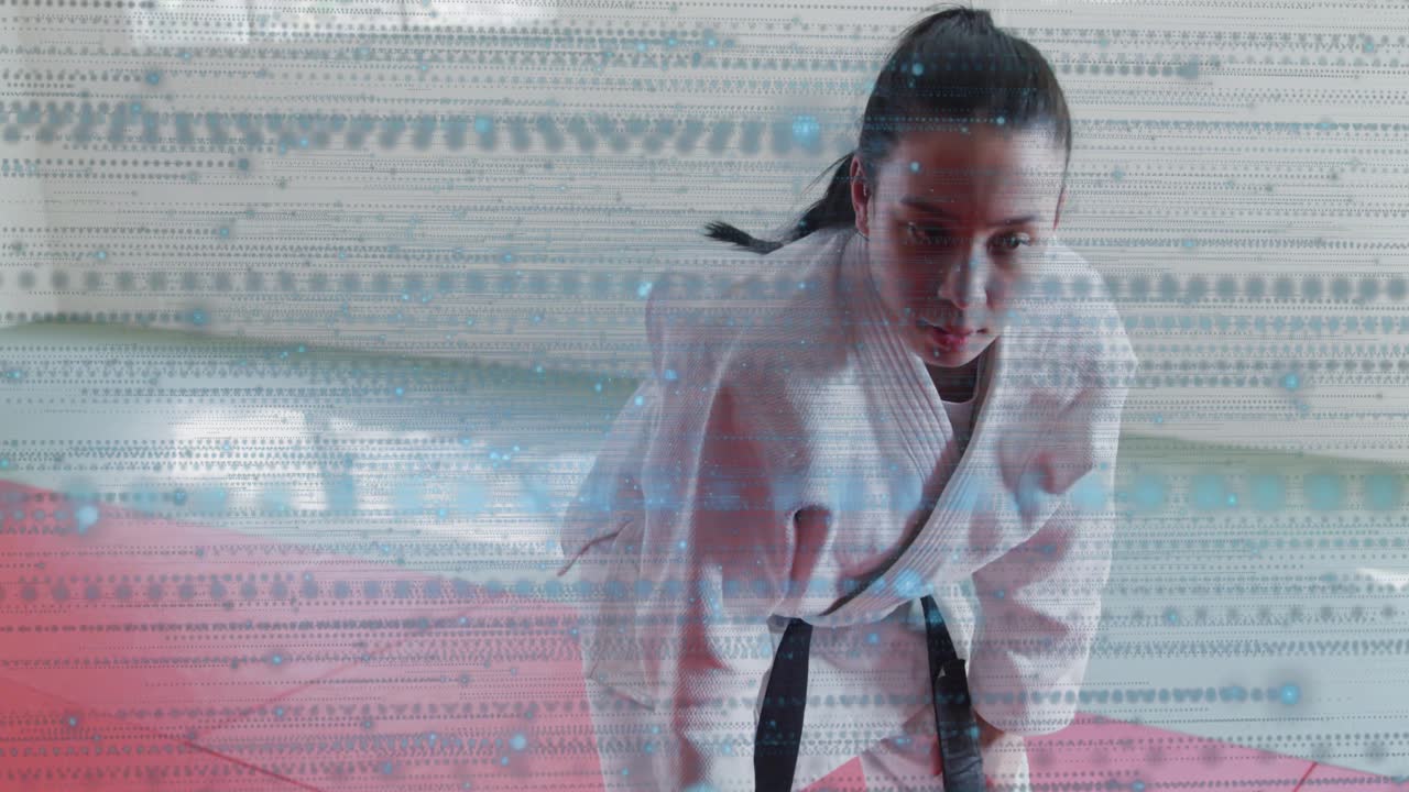 Male martial artist reaching mat, shielding face, resetting training posture, glitch obscuring face