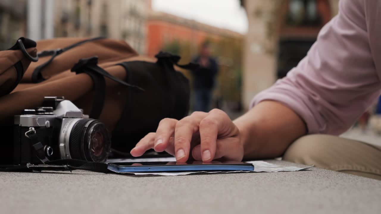 Man tourist using smart phone searching location in map application online close up macro. Backpacker using GPS to find destination on vacation. City or Forest hiking, walking in europe