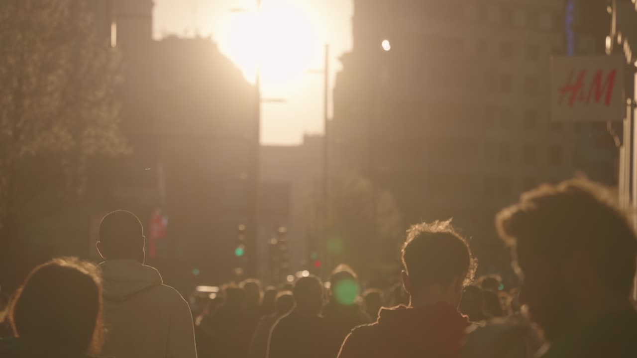 Crowd of People on a City Street at Sunset