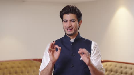 Happy-and-smiling-Indian-man-showing-Okay-hand-gesture