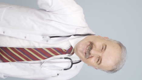 Vertical-video-of-Dancing-old-doctor.-Happy-and-cute.