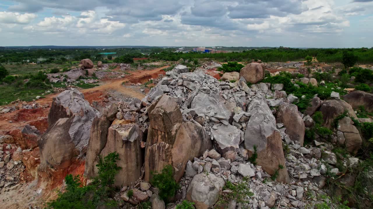 stone mining with surrounding greenery and clouds in sky at telangana, india. day time, push back, drone shot, 4k.