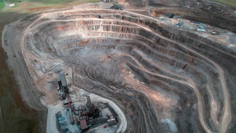 Yorkshire-aggregate-mining-quarry-aerial-view-tilting-upwards-to-countryside-scenery