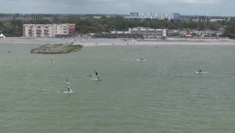 makkum beach with windsurfers during a stormy day, aerial