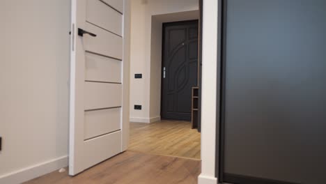 wide shot interiors on new apartment with no people indoors. view from bedroom to corridor in flat.