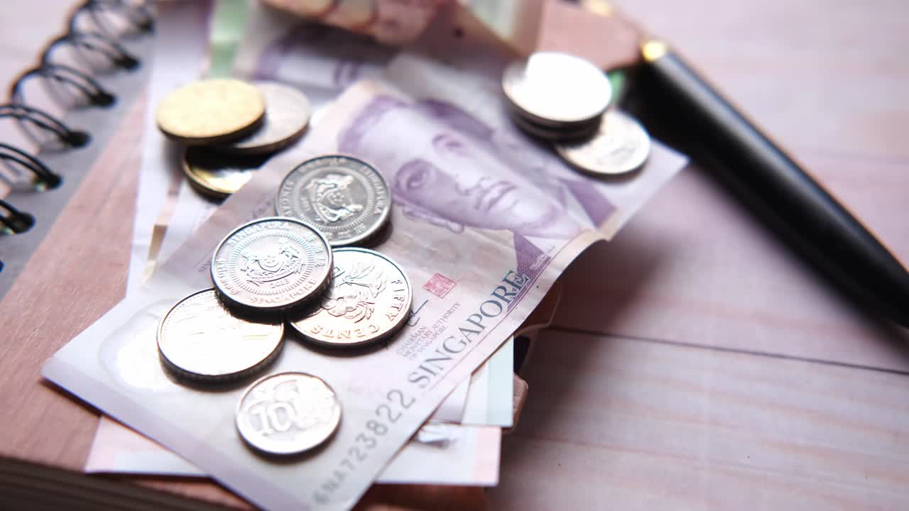 Singapore Currency and Coins on a Notebook