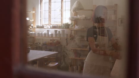 young female potter working in her studio