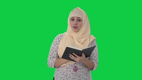 happy muslim teacher teaching in school green screen