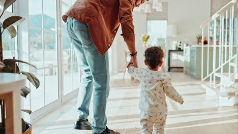 a father and child walking together at home