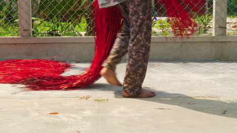 Drying-colored-straw-used-for-handmade-mattress-in-the-sun