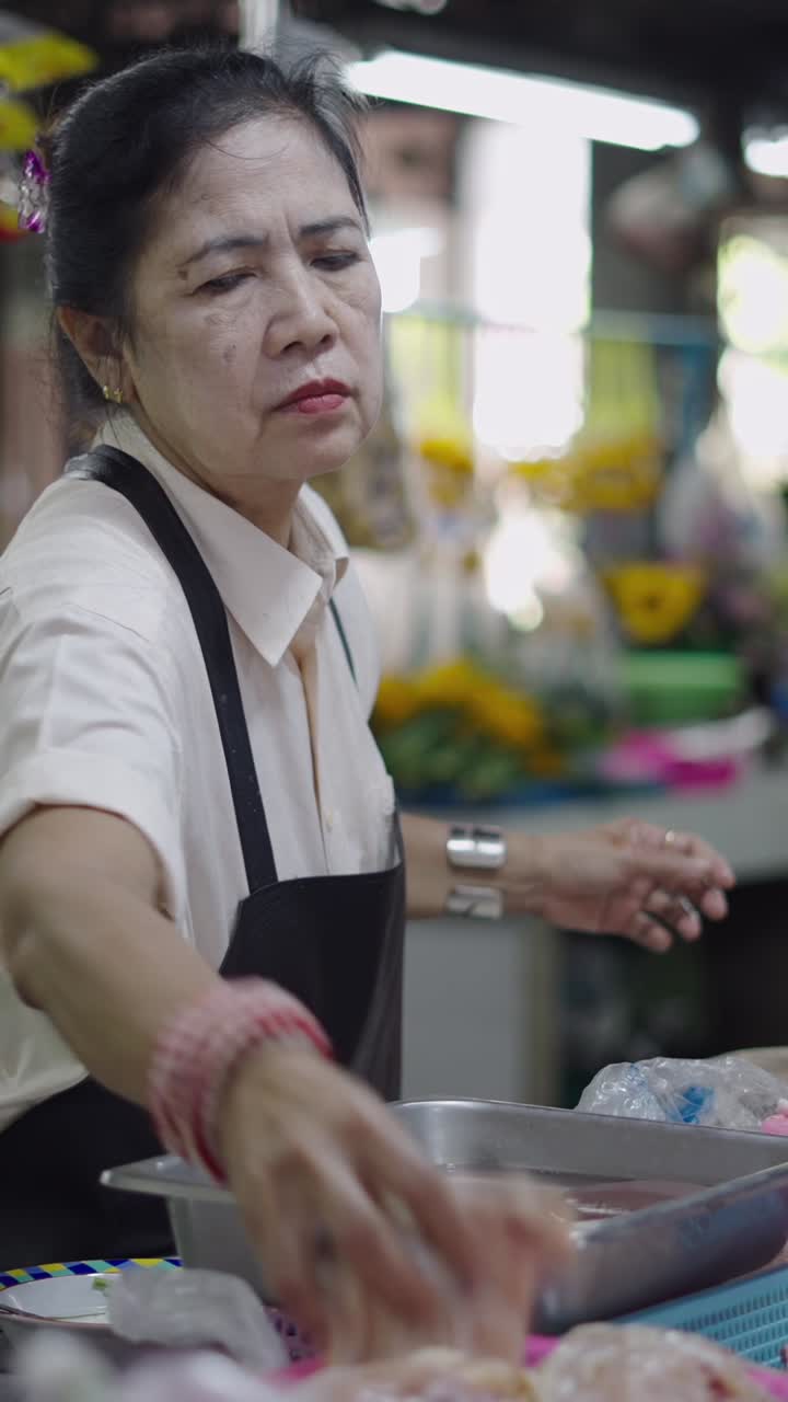 Food vendor preparing chicken at a market