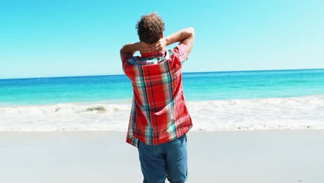 excited man standing with arms out stretched