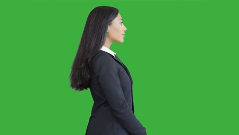 lifestyle portrait of young african american business woman isolated on green screen chroma key background