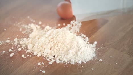 flour and eggs on a wooden surface, ingredients for baking